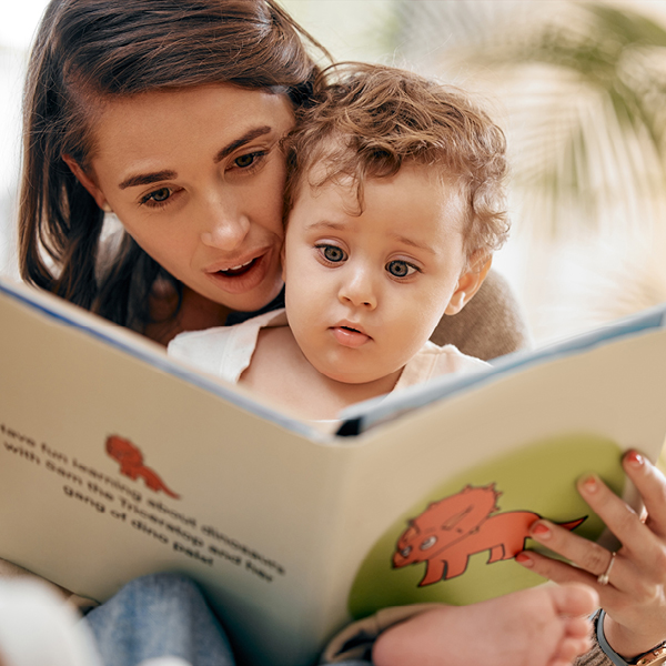 caregiver and small child reading